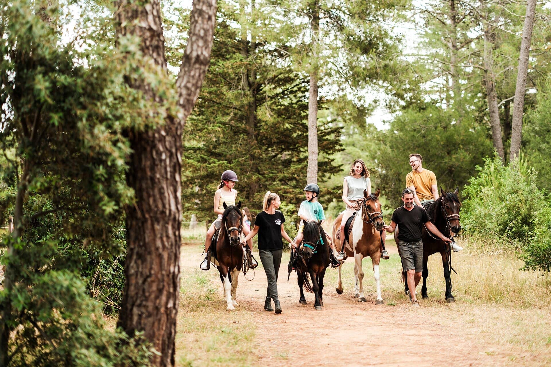 Family horseback riding through forest trail as part of activities at Zaton Holiday Resort Zaton Holiday Resort