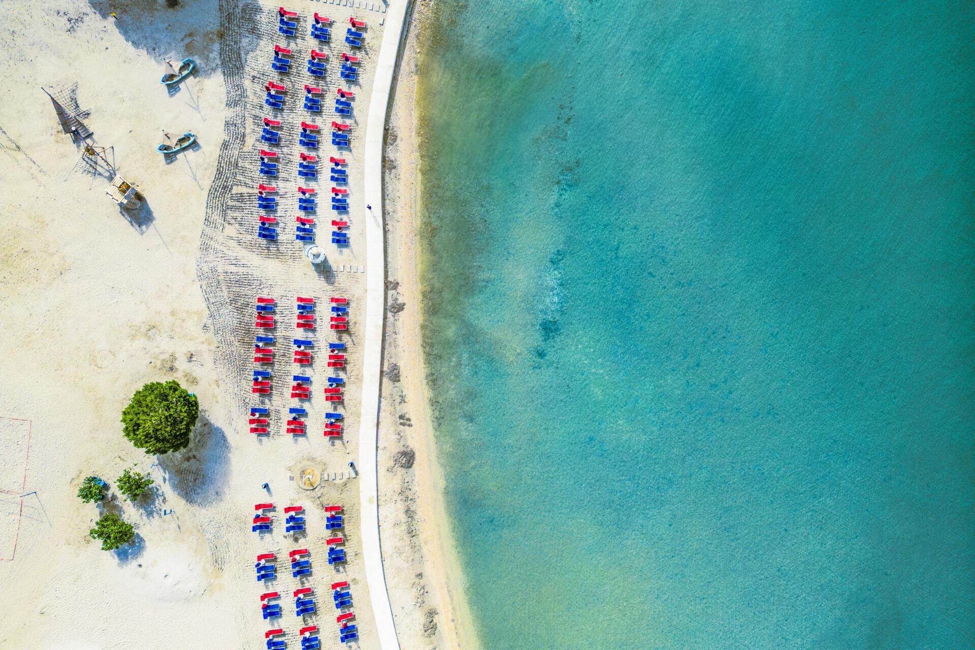 Aerial view of sandy beach and sunbeds along the coast at Zaton Holiday Resort Zaton Holiday Resort